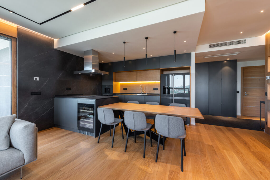 Luxury kitchen and dining room interior with brown parquet floor